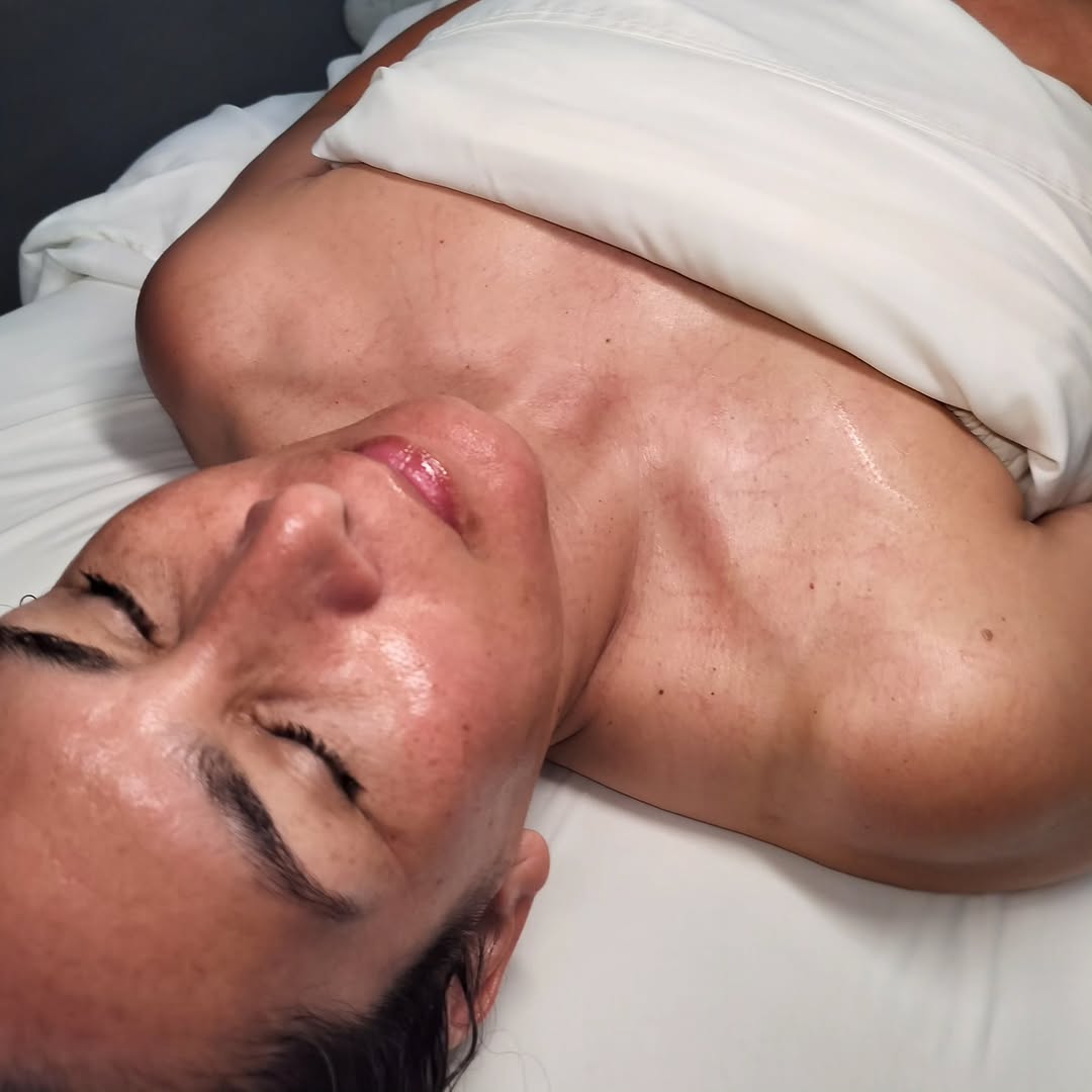 Client relaxing with a glowing complexion after a facial